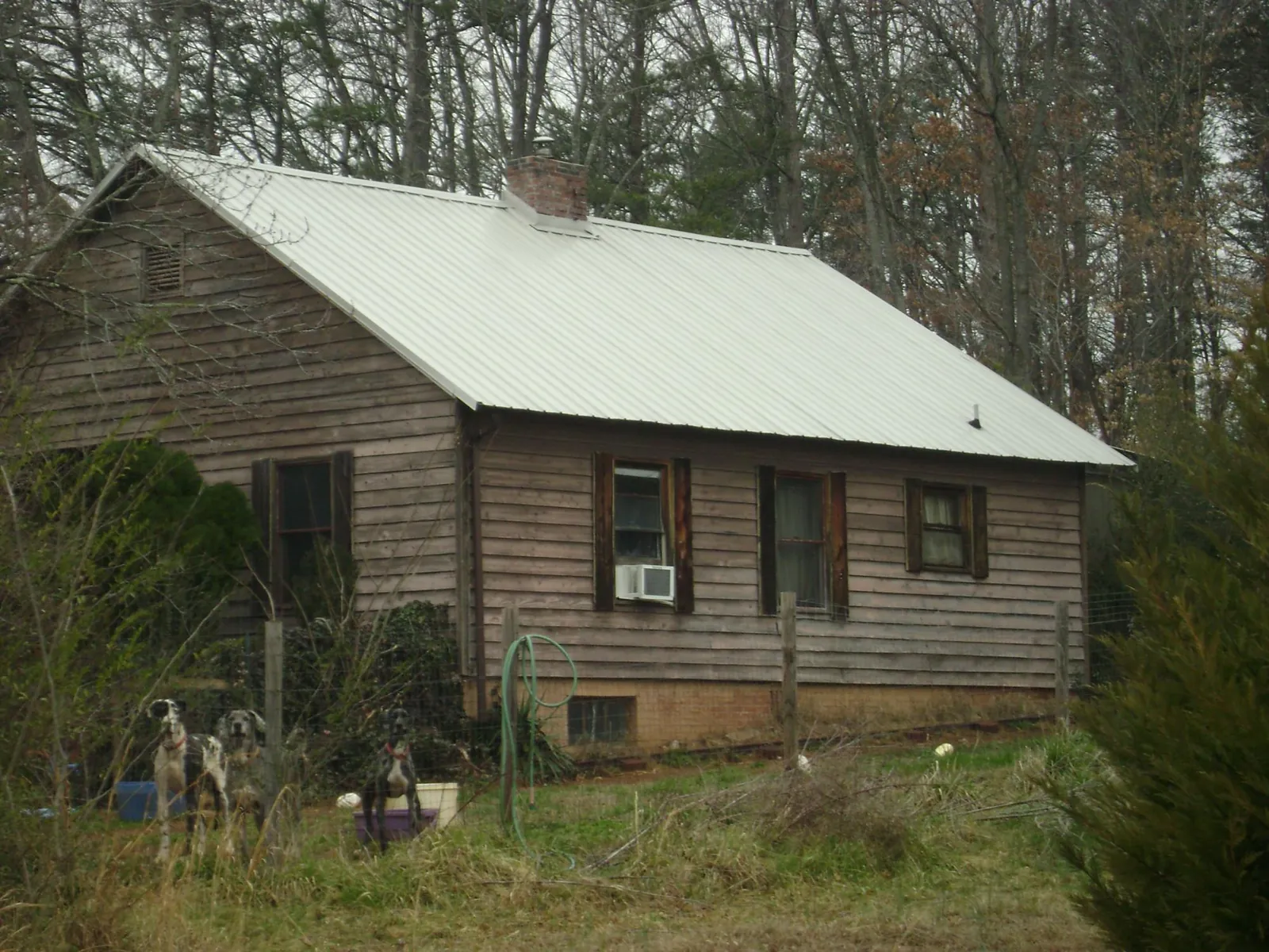 White metal roof on an old wood sided farmhouse, from a Metal Roof Installation job in Gobles